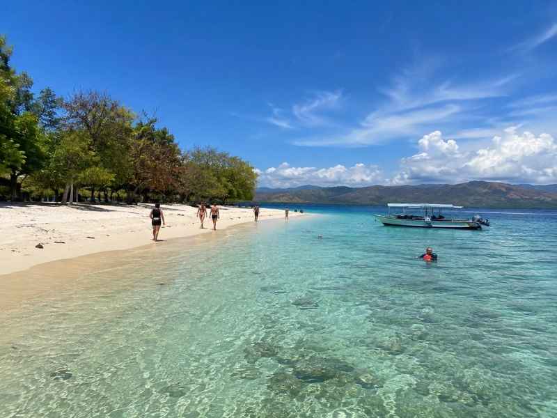 Gili Nanggu snorkeling trip with crystal-clear sea, quiet beach, and a local island boat