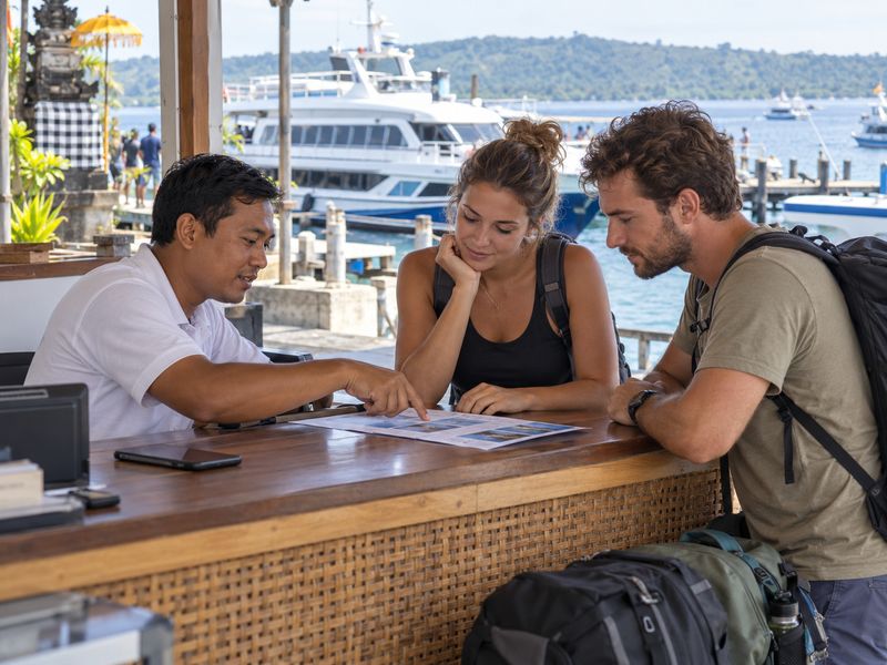 Discussing boat tickets at Bali harbour