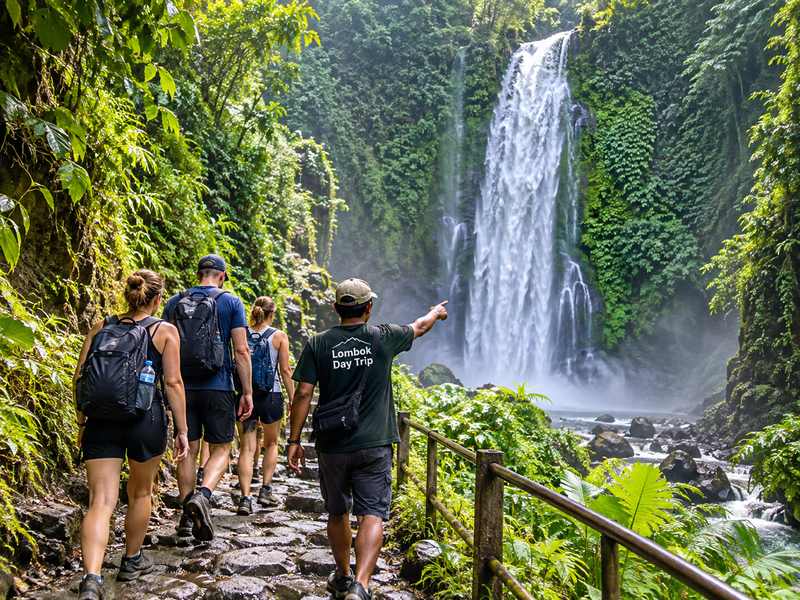 Sendang Gile waterfall guide walking with visitors in Senaru Lombok
